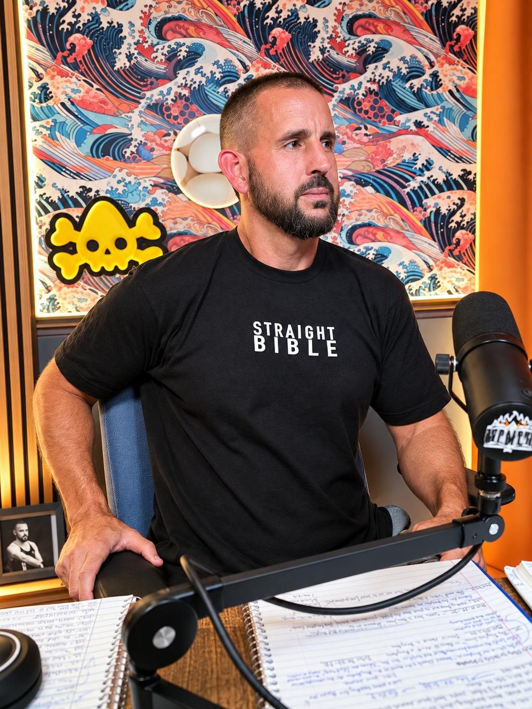 Matt Hepner at the microphone in a Straight Bible shirt